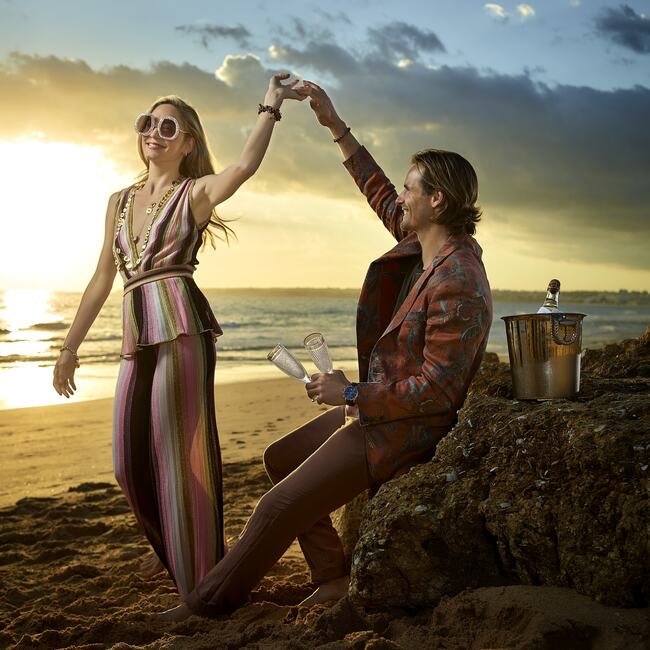 VILA Hibiscus photoshoot: Couple having drinks by the ocean.