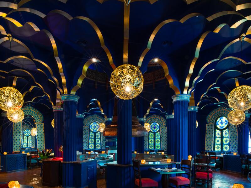 Restaurant with arabian-inspired décor in shades of blue and gold.