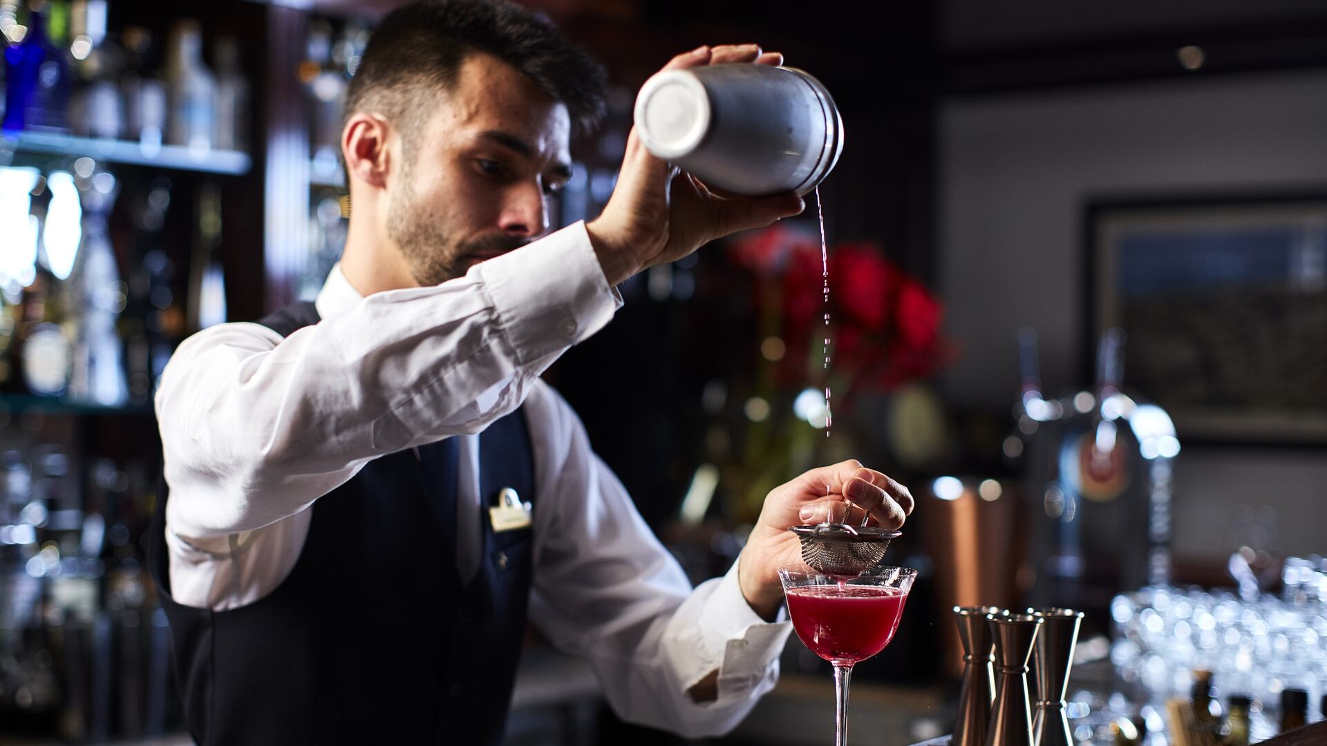 Oasis Bar Bartender preparing cocktail.