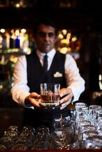 Oasis Bar Bartender handling drink