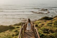 V-Life Fashion Shoot: Woman walking by the beach.