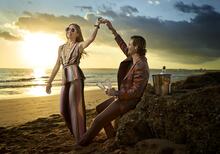 VILA Hibiscus photoshoot: Couple having drinks by the ocean.