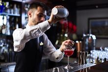 Oasis Bar Bartender preparing cocktail.